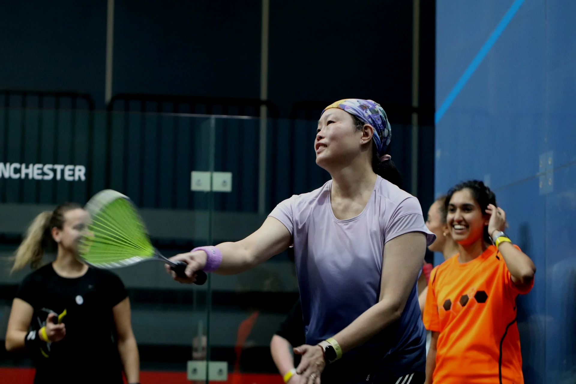Women playing squash at a Girls In Motion event